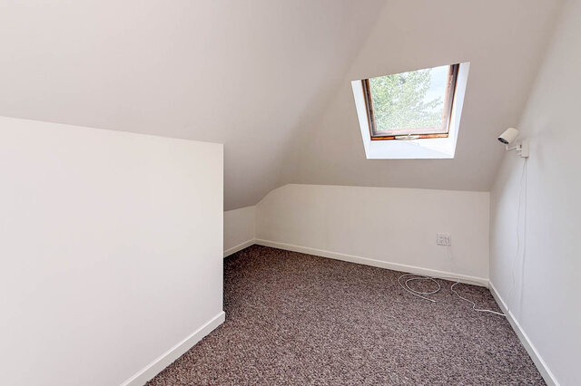 Bright living space with hardwood floors and tree-lined view through large windows. - 3443 West 6th Ave, Vancouver West Side