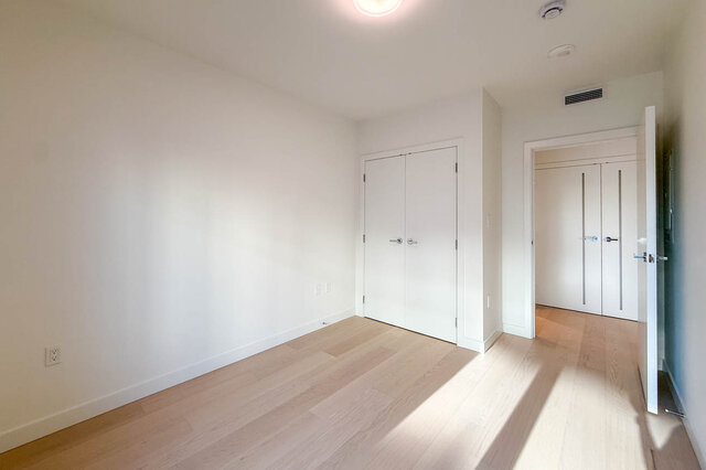 Bright den with light wood floors and white walls. - 406-777 Harbour Way, North Vancouver
