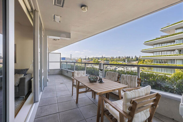 Balcony with wooden dining set and panoramic city-greenery view. - 204-866 Arthur Erickson Place, West Vancouver