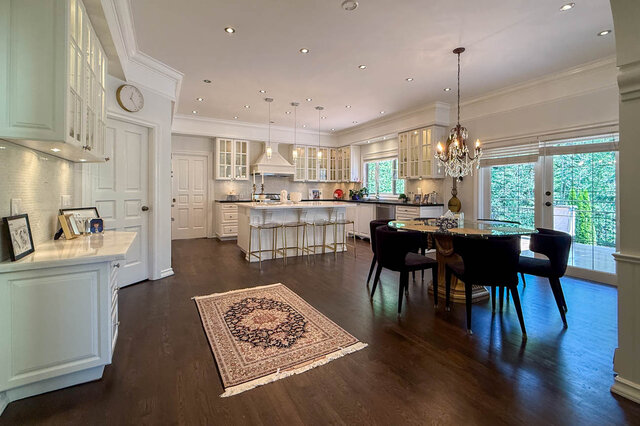 Bright, spacious kitchen with dining area, hardwood floors, and large windows overlooking greenery. - 1249 Chartwell Place, West Vancouver