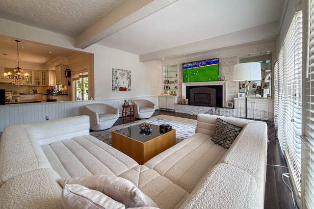 Spacious living room with a fireplace, large windows, and modern furnishings - 1249 Chartwell Place, West Vancouver