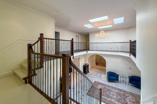 A spacious living room with a grand staircase, skylights, and elegant furnishings - 1249 Chartwell Place, West Vancouver