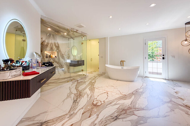 A luxurious bathroom with marble flooring, freestanding tub, and glass shower enclosure. - 1249 Chartwell Place, West Vancouver