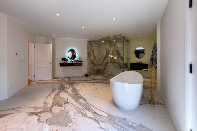 Spacious luxury bathroom with marble flooring, freestanding tub, and glass shower enclosure - 1249 Chartwell Place, West Vancouver
