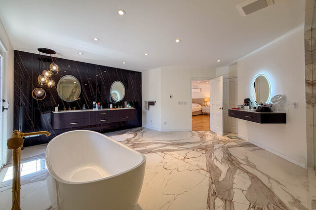 Luxurious bathroom with marble flooring, freestanding tub, and double vanity - 1249 Chartwell Place, West Vancouver