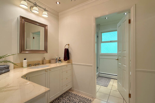 A bright bathroom with marble countertops and recessed lighting - 1249 Chartwell Place, West Vancouver