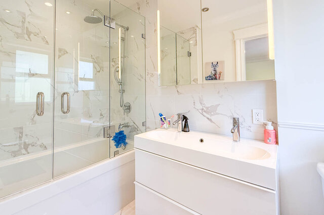 Modern bathroom with glass-enclosed shower and white vanity. - 1249 Chartwell Place, West Vancouver