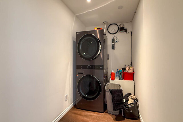 Clean, organized laundry room with stacked washer/dryer and laundry supplies - 1249 Chartwell Place, West Vancouver