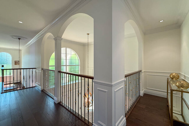 A bright, spacious lobby with arched windows and dark hardwood floors - 1249 Chartwell Place, West Vancouver