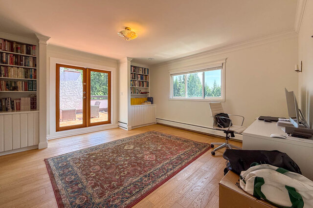 Bright, spacious den with hardwood floors, built-in bookshelves, and French doors to a balcony - 1249 Chartwell Place, West Vancouver