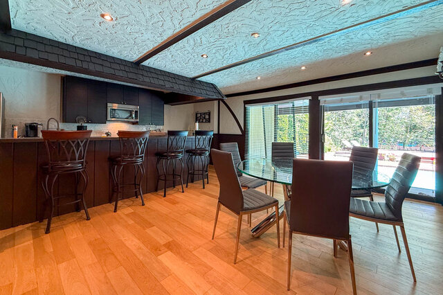 Spacious kitchen with dining area, hardwood floors, and large windows. - 1249 Chartwell Place, West Vancouver