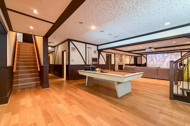 Spacious den featuring hardwood floors, a pool table, and a large projector screen. - 1249 Chartwell Place, West Vancouver