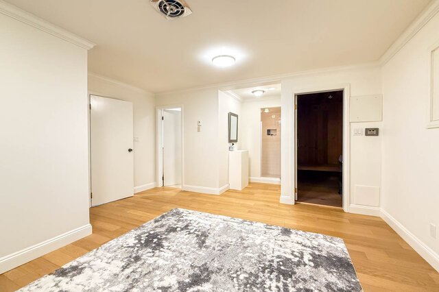 Spacious living room with hardwood floors and multiple doorways. - 1249 Chartwell Place, West Vancouver