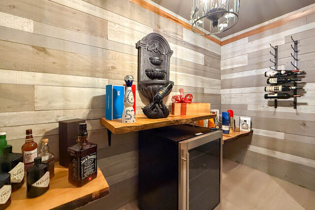Cozy home bar lounge with wooden plank walls and wine storage - 1249 Chartwell Place, West Vancouver