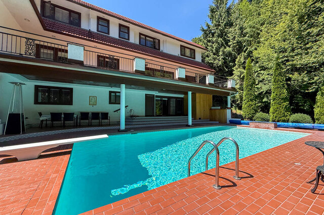 Exterior view of a multi-story building with a pool and balcony. - 1249 Chartwell Place, West Vancouver