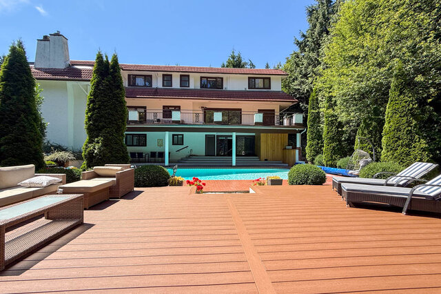 Exterior view of a multi-story building with a pool, wooden deck, and landscaped garden - 1249 Chartwell Place, West Vancouver