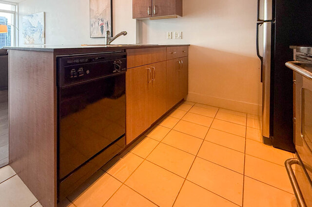 Bright kitchen with glossy tile flooring and contemporary wood cabinetry. - 2113-610 Granville Street, Vancouver Downtown