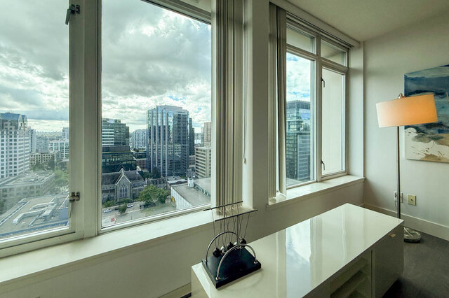 Spacious den with panoramic city view and sleek white countertops. - 2113-610 Granville Street, Vancouver Downtown