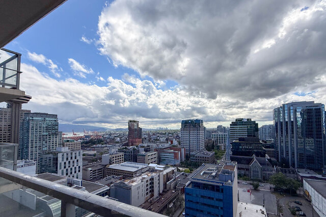 Balcony with panoramic Vancouver skyline and glass-clad skyscrapers under dramatic clouds. - 2113-610 Granville Street, Vancouver Downtown