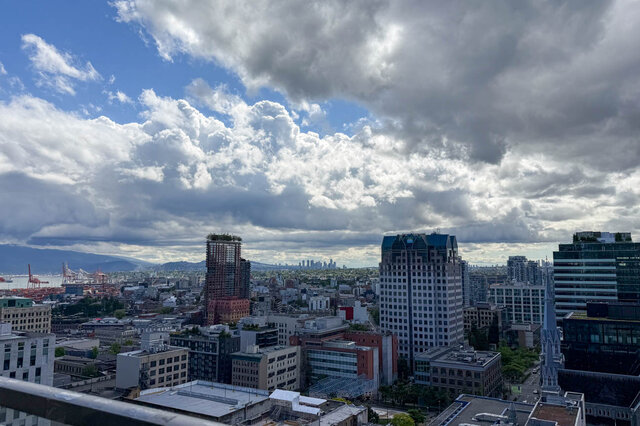 Balcony with panoramic city view and modern skyscrapers under dramatic clouds. - 2113-610 Granville Street, Vancouver Downtown