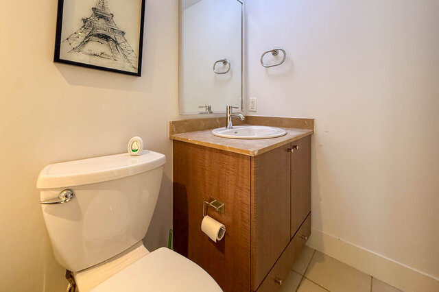 Bright bathroom with marble countertop vanity and Eiffel Tower wall art. - 2113-610 Granville Street, Vancouver Downtown