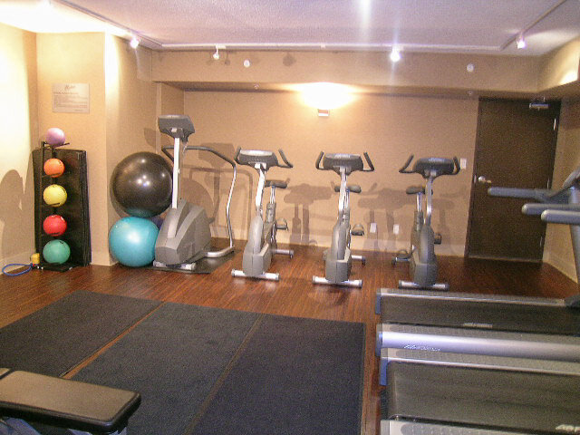 Gym with stationary exercise bikes, colorful stability balls, and polished hardwood floors. - 2113-610 Granville Street, Vancouver Downtown