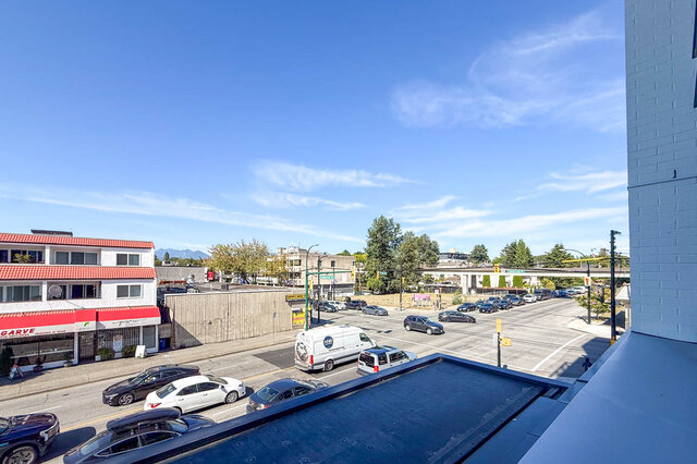 Balcony with city view and clear blue sky. - 204-1680 East 12th Avenue, Vancouver East Side