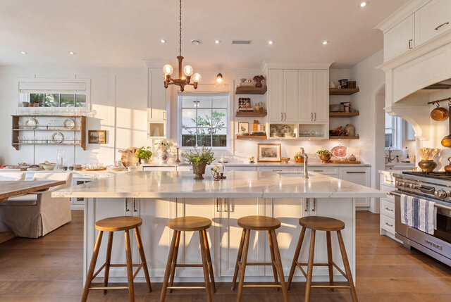 A bright, spacious kitchen with white cabinetry, hardwood floors, and stainless appliances. - 1248 Kings Avenue, West Vancouver
