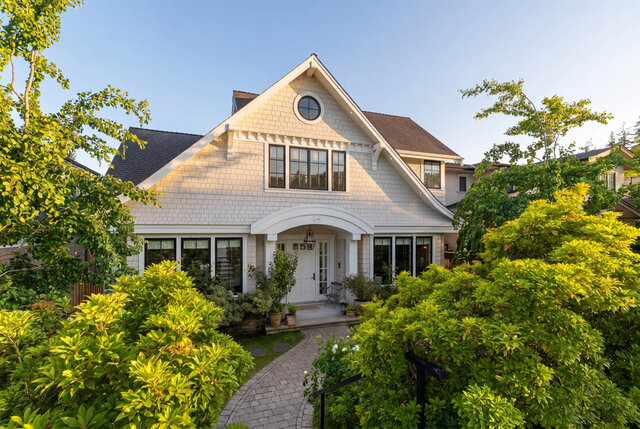 Exterior view of a white shingle house with large windows and lush landscaping - 1248 Kings Avenue, West Vancouver