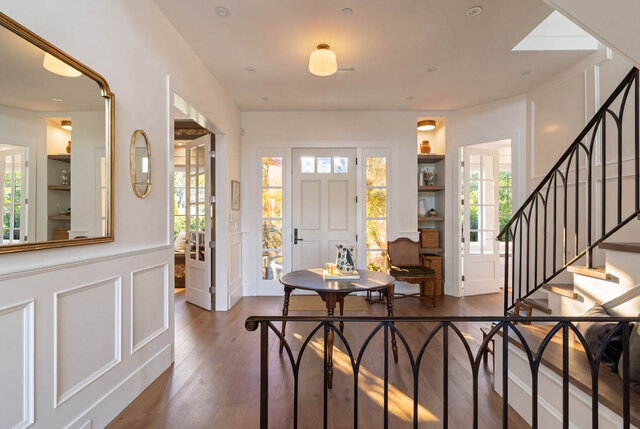 Bright entrance hall with hardwood floors, large mirror, and glass-paneled doors - 1248 Kings Avenue, West Vancouver
