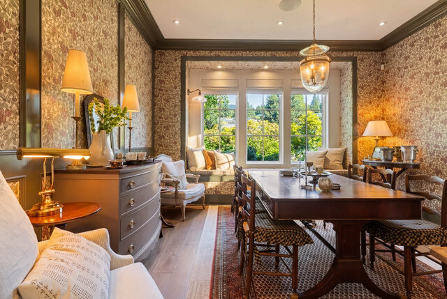 A well-lit dining area with patterned wallpaper, hardwood floors, and large windows overlooking greenery. - 1248 Kings Avenue, West Vancouver