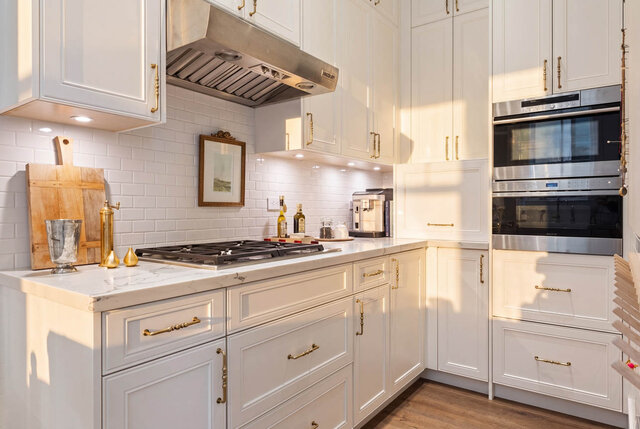A bright, modern kitchen with white cabinetry and stainless steel appliances - 1248 Kings Avenue, West Vancouver
