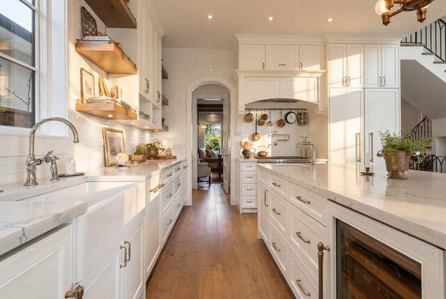 A bright, spacious kitchen with white cabinets, marble countertops, and hardwood floors. - 1248 Kings Avenue, West Vancouver