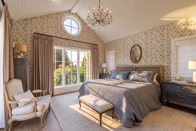 A bright, elegantly decorated bedroom with floral wallpaper, large windows, and a cozy bed setup. - 1248 Kings Avenue, West Vancouver