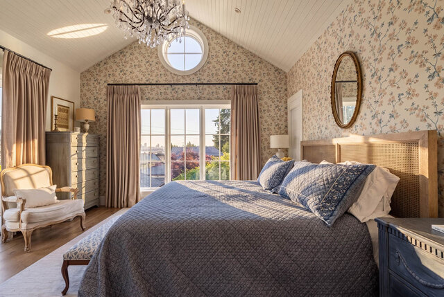 Sunlit bedroom with floral wallpaper, large windows, and a chandelier. - 1248 Kings Avenue, West Vancouver