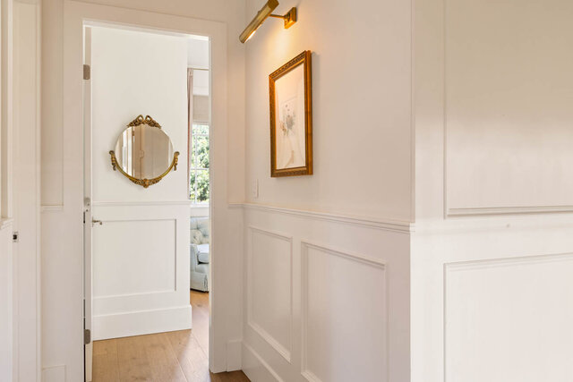 A bright hallway with white wainscoting and hardwood flooring - 1248 Kings Avenue, West Vancouver