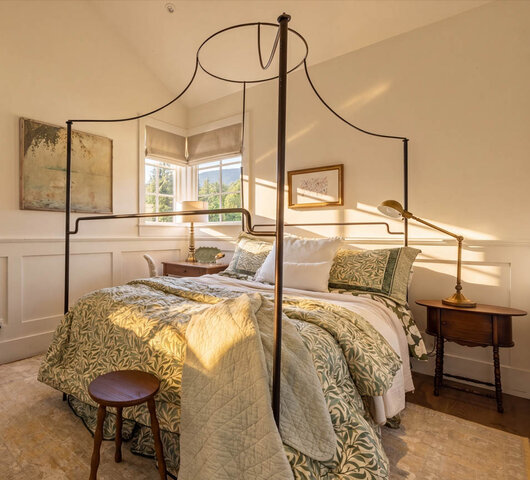 Sunlit bedroom with canopy bed, bay window, and wooden furnishings. - 1248 Kings Avenue, West Vancouver