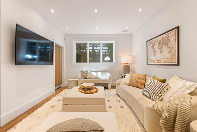 A bright, modern living room with large windows, hardwood floors, and comfortable seating - 1248 Kings Avenue, West Vancouver