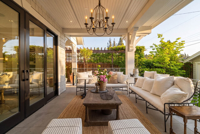 Covered outdoor balcony with large sliding glass doors and outdoor furniture - 1248 Kings Avenue, West Vancouver