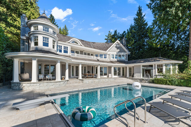 The pool area features a swimming pool with a life ring, a 'LOVE' buoy, lounge chairs, and a stone patio surrounding the pool