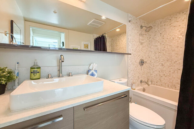 Bathroom with white vessel sink and mosaic tile shower wall. - 505-189 Keefer Street, Vancouver Downtown