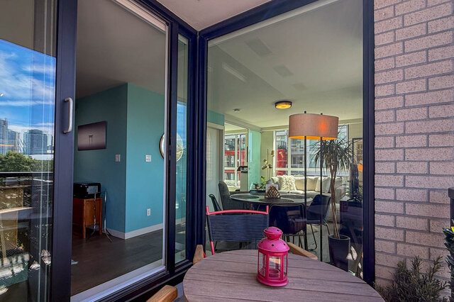 Spacious living room with city view and teal walls. - 505-189 Keefer Street, Vancouver Downtown