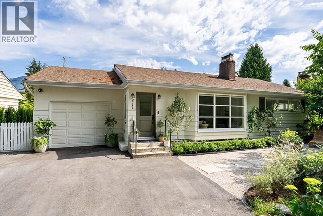 The building exterior features a single-story house with a garage, front door, large windows, chimney, and potted plants.