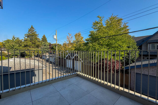 Sunny balcony with clear blue sky and mature green trees. - 3038 Vine Street, Vancouver West Side