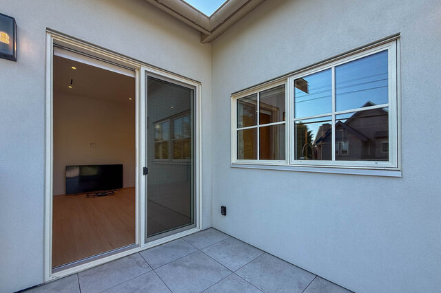 Patio with tile flooring and sliding door revealing hardwood floors inside. - 3038 Vine Street, Vancouver West Side