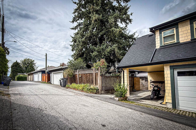 Laneway view of a yellow brick laneway house with. - 3752 West 23rd Avenue, Vancouver West Side