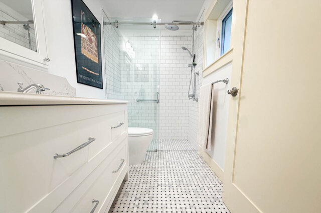 Bathroom with white vanity, walk-in shower in subway tile, and black-and-white mosaic floor. - 3752 West 23rd Avenue, Vancouver West Side