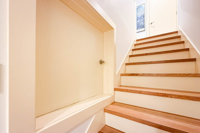 Bright stairway with oak treads and a built-in cream storage nook. - 3752 West 23rd Avenue, Vancouver West Side