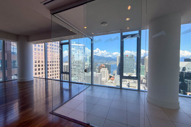 Open living space with hardwood floors and floor-to-ceiling windows framing a. - 2702-667 Howe Street, Vancouver Downtown