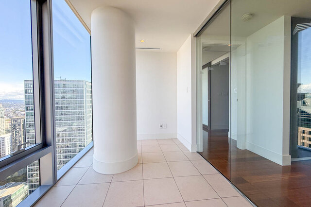 Bright entryway with floor-to-ceiling windows, city view, and a glass sliding door. - 2702-667 Howe Street, Vancouver Downtown